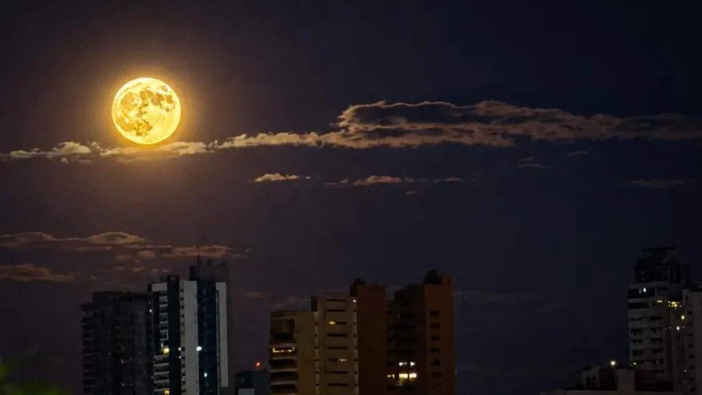 Brazil's Campo Grande sky glows with orange full moon